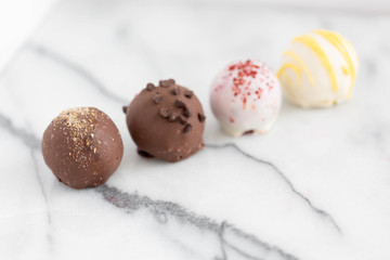Assorted truffles on white marble background