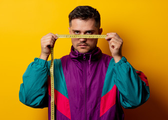 Style man in 90s tracksuit with measuring tape