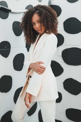 Female model in white suit posing