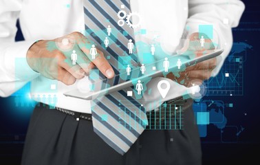 Man holding   digital tablet on background