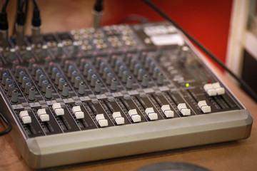 Shallow depth of field (selective focus) image with the controls on an audio mixer