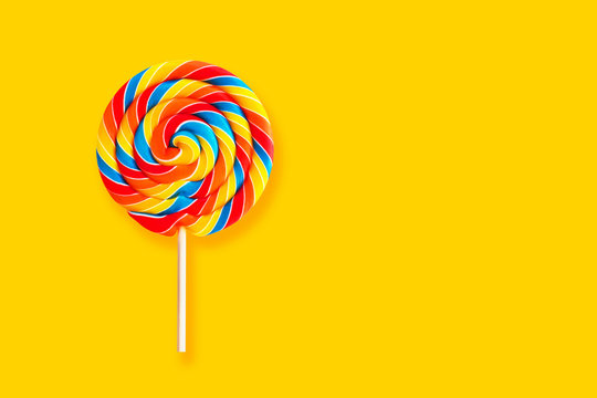 Colorful lollipop swirl on stick. Striped spiral multicolored candy