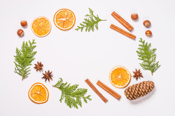 Christmas flat lay background with fir tree and spices on white.