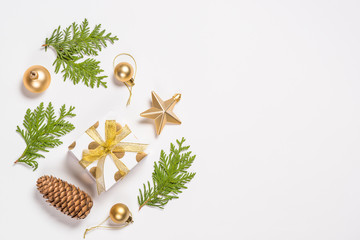 Christmas flat lay background with golden decorations on white.