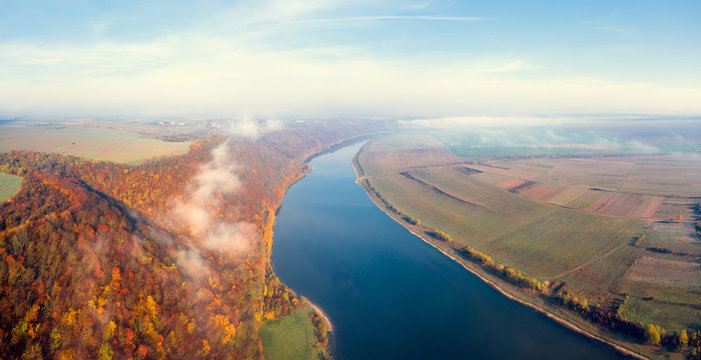 Autumn landscape with blue sky and river