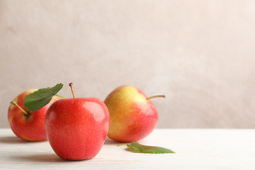 Apples on white wooden background, space for text