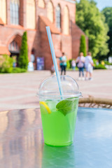 Green alcohol free mojito in plastic cup.