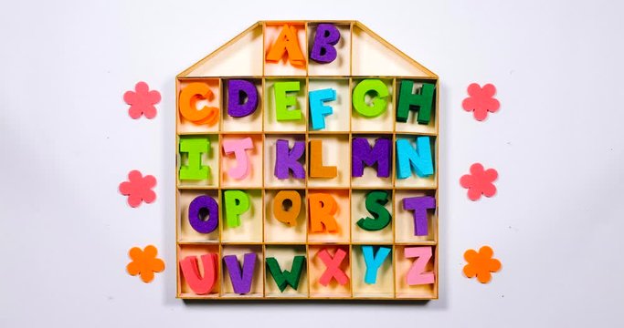 Stop Motion. The English alphabet moves in the cells of the house.