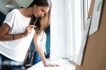 Obraz premium Portrait of young female architect working on project.