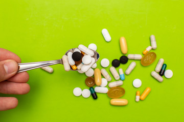  Pills, tablets and capsules from assorted pharmaceuticals in the background. Different Pills for health.