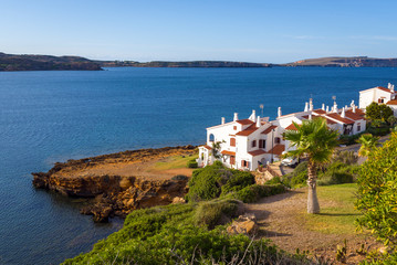 Fototapeta na wymiar Menorca island in Spain - beautiful landscape with summer villas on the seafront