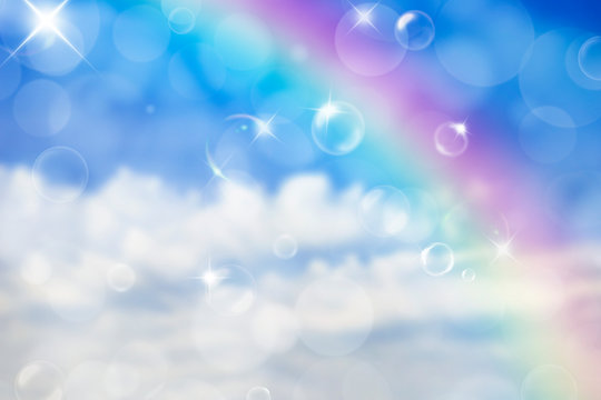 Blurred background with bubbles in blue sky above the rainbow. Heaven illustration. Soft magic effect. Background for birthday party, festival in summer. Fairy tale decoration.