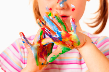 Beautiful young girl with colorful painted hands. Selective focus on hands. Art,  creativity and childhood concept. © zwiebackesser