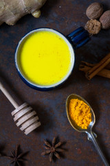 Turmeric golden milk in a small blue cup