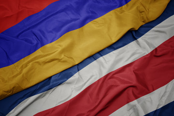waving colorful flag of costa rica and national flag of armenia.