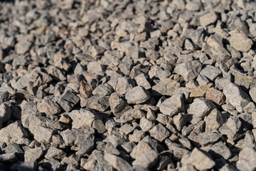 A large pile of bulk 57 gravel sits ready to be used on a job site for a DIY home improvement...