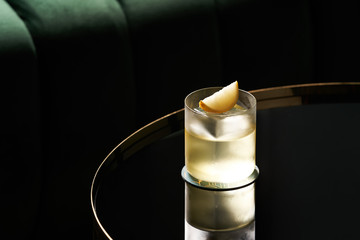Classic cocktail glass on glass table in night club restaurant, close-up