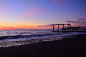 Fototapeta na wymiar sunset on the beach and boats on the shore