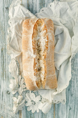 Freshly baked wheat bread, homemade cakes, still life with bread, crisp loaf of bread, still life on a rustic background, top view, rustic bread, roll, loaf.