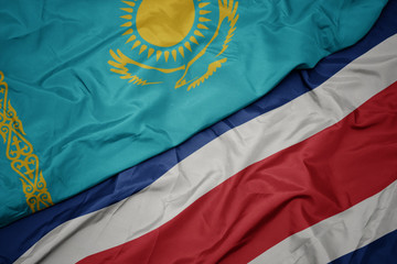 waving colorful flag of costa rica and national flag of kazakhstan.