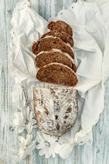 Freshly baked wheat bread, homemade cakes, still life with bread, crisp loaf of bread, still life on a rustic background, top view, rustic bread, roll, loaf.