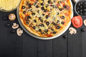 Flat lay of italian pizza and ingredients. Pizzeria, restaurant, recipe book, home cooking. Horizontal photo with space for design.