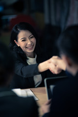 Good deal. Close-up of two business people shaking hands while sitting at the working place