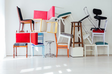 different multicolored chairs in the interior of the white room