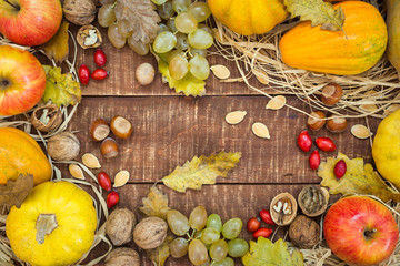 Autumn composition with fresh fruits, pumpkins and nuts