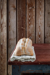 Freshly baked wheat bread, homemade cakes, still life with bread, crisp loaf of bread, still life on a rustic background, top view, rustic bread, roll, loaf.