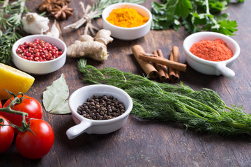 Herbs and spices in ceramic bowls. Aromatic ingredients and natural food additives.