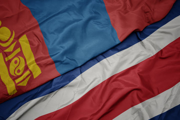waving colorful flag of costa rica and national flag of mongolia.