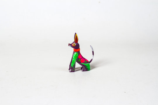 Mexican purple xolo dog alebrije from oaxaca isolated on white background. Side view
