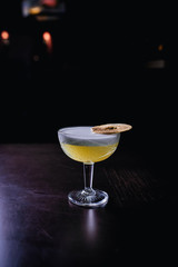 yellow coctail with orange and cinnamon