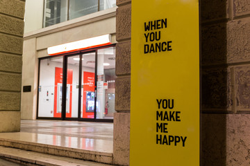 When you dance you make me happy quote on a board in city center