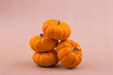 Four mini pumpkins for Halloween on the paper. Decor.