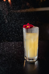 yellow coctail with flowers and spray