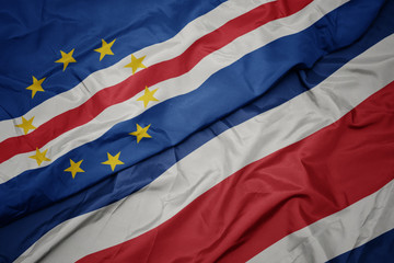 waving colorful flag of costa rica and national flag of cape verde.