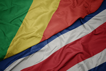 waving colorful flag of costa rica and national flag of republic of the congo.