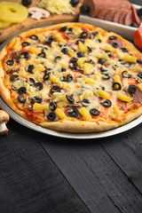 Italian pizza and ingredients. Pizzeria, restaurant, recipe book, home cooking. Vertical photo with space for design.