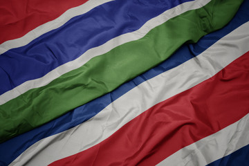 waving colorful flag of costa rica and national flag of gambia.