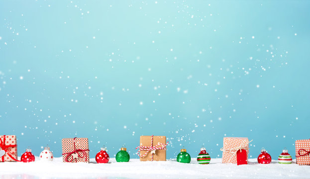 Collection of Christmas gift boxes in a snow covered landscape