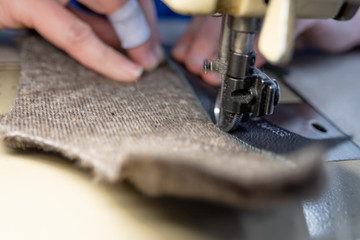 Sewing details of fur and leather. Shoe production.