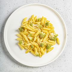 Penne pasta with romanesco cabbage on light gray background