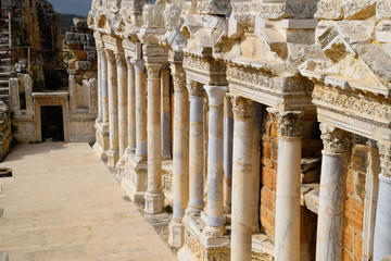 Naklejka premium Columns on the stage of the amphitheater. Ancient antique amphitheater in city of Hierapolis in Turkey.
