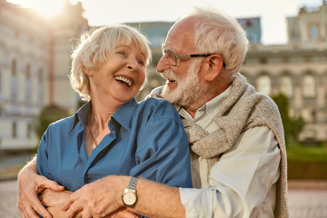 Feeling happy with you. Cheerful senior couple in casual clothing embracing each other and laughing...