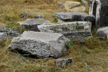 Fragments of ancient buildings, ruins of the ancient city of Hierapolis. Stone blocks with traces...