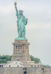 Statue of Liberty with cloudy sky.