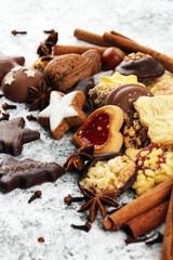 christmas cookies with spieses, nuts and fruits on rustic table