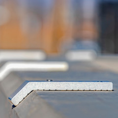 Square frame Metal pegs that are designed to stop skateboards and roller blades